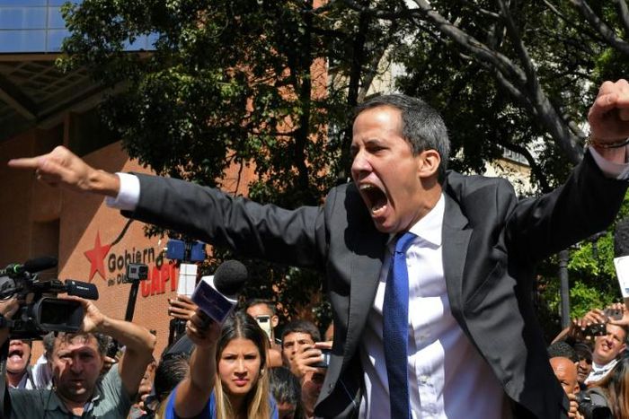 Venezuelan opposition leader and self-proclaimed acting president Juan Guaido shouts on his way to the National Assembly, in Caracas, on January 7, 2020, where he claimed the speaker's chair