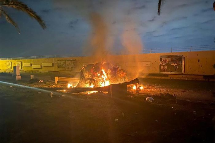 A picture published by the media office of the Iraqi military's joint operations forces shows a destroyed vehicle on fire following a US strike on Baghdad international airport road in which top Iranian commander Qasem Soleimani was killed