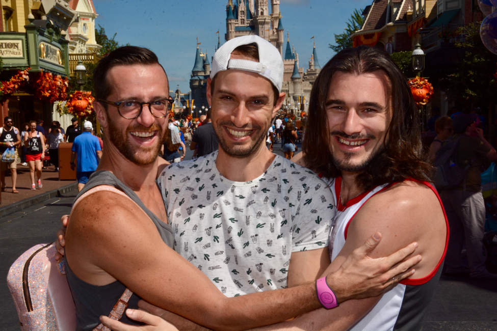 Asher with his husband and third partner.