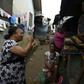 Grassroots message: MSF volunteer Christine Harrison, left, talks to a family about sexual abuse