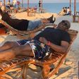 Fayose sunbathes on a beach abroad (Fayose media)