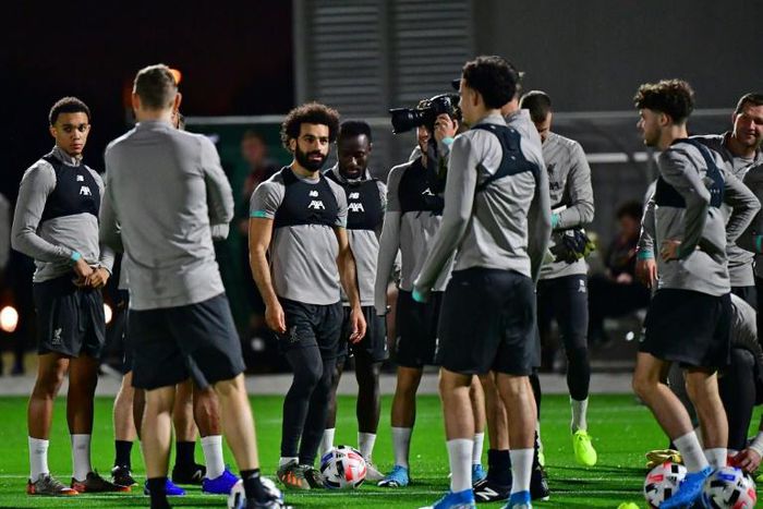 Mohamed Salah (C) and his Liverpool teammates train in Doha on Monday as manager Jurgen Klopp watches on