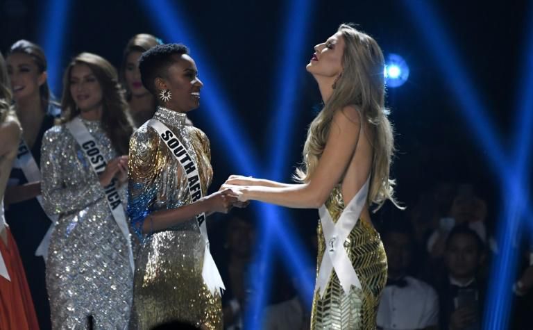 Miss South Africa Zozibini Tunzi (L) and Miss Puerto Rico Madison Anderson (R), the two finalists, wait to hear the winner's name on stage during the 2019 Miss Universe pageant at the Tyler Perry Studios in Atlanta, Georgia