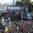 Iranian mourners gather around a vehicle carrying the coffin of slain top general Qasem Soleimani during the final stage of funeral processions, in his hometown Kerman