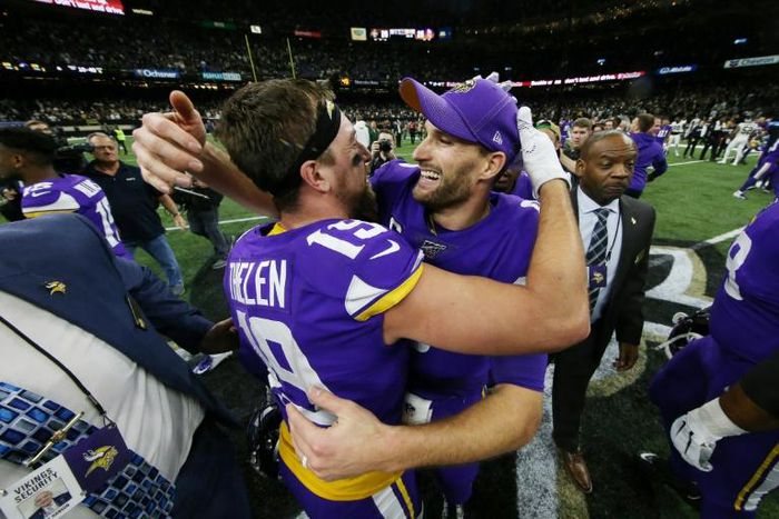 Minnesota Vikings quarterback Kirk Cousins, right, celebrates with Adam Thielen, left, after the Vikings defeated the New Orleans Saints 26-20 in the NFL playoffs Sunday