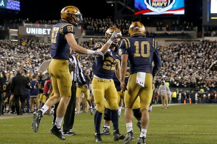The Navy Midshipmen celebrate a touchdown in Saturday's game against the Army Black Knights