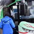 Riot police officers stand guard by a bus carrying illegal migrants following the evacuation of the makeshift camp Vucjak on the outskirts of Northern-Bosnian town of Bihac, on December 10, 2019