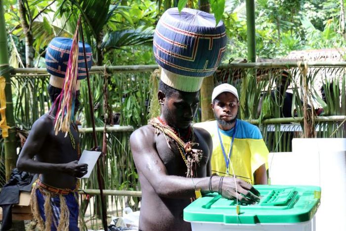 Young Upe men cast their votes in the Bougainville Referendum at the men's only polling station in Teau Bougainville, Papua New Guinea.