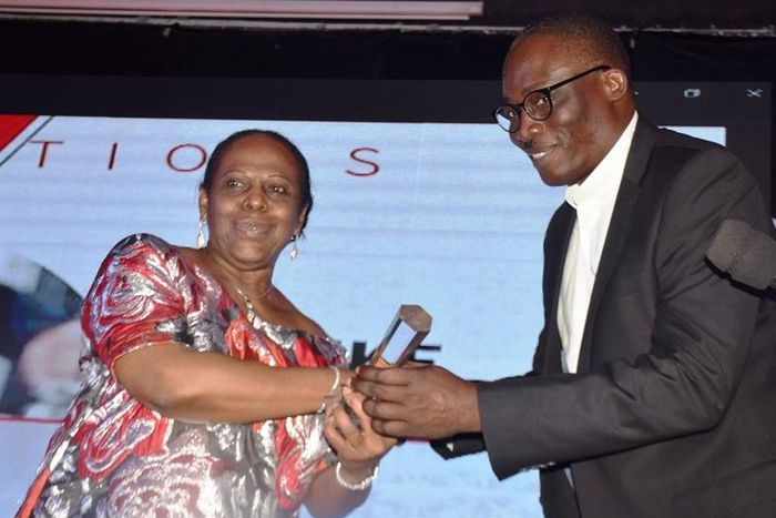 Globacom’s National Commercial Coordinator, Mr. Yomi Ogunbamowo, receiving  the Platinum Award of Nigeria’s Outstanding and Most Innovative Entrepreneur conferred on Globacom Chairman, Dr. Mike Adenuga, Jr., from the Publisher, Nigerian Tribune titles,...