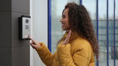 woman-using-smart-doorbell