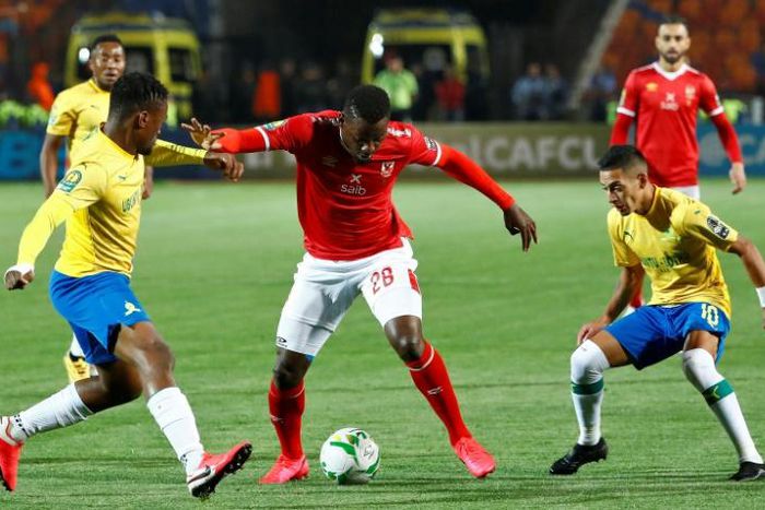 Junior Ajayi (C) of Al Ahly tries to get past Motjeka Madisha (L) and  Gaston Sirino of Mamelodi Sundowns in Cairo Saturday