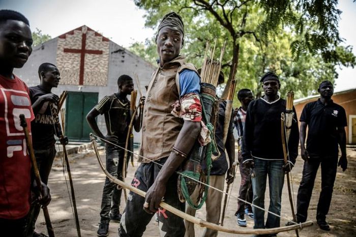 Land of tensions: Hunters armed with bows and arrows gathered in Dasso, central Nigeria, in February pledging to defend farmers in conflict with nomadic herdsmen