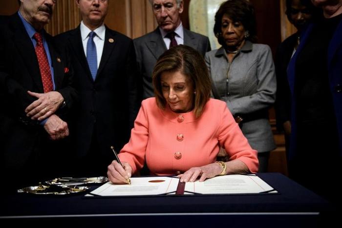 US House Speaker Nancy Pelosi signs the articles of impeachment against President Donald Trump