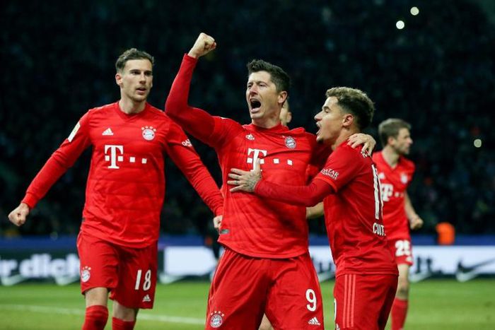 Bayern Munich's Poland forward Robert Lewandowski (C) celebrates scoring his 20th league goal this season after converting a penalty in Sunday's 4-0 away drubbing of Hertha Berlin.