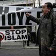 An anti-migrant rally in Athens where a journalist was attacked