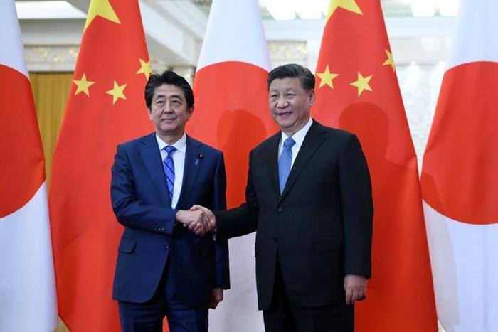 Japan's Prime Minister Shinzo Abe (left) shakes hand with China's President Xi Jinping at the Great Hall of the People in Beijing in December 2019