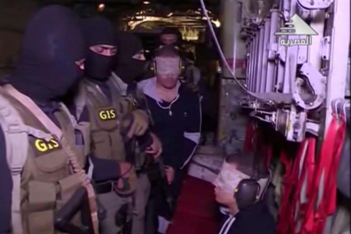 An image from May 29, 2019 shows Hisham Ashmawy (C) aboard a military aircraft after being handed over by forces loyal to Libyan strongman Khalifa Haftar