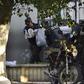 Honduran military police carry the body of a colleague after the escape of MS-13 gang leader Alexander Mendoza on February 13, 2020