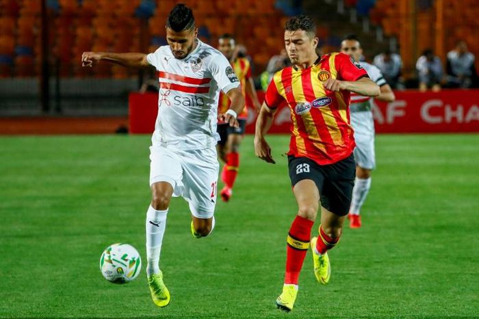 Mohamed Ounajem (L) of Zamalek attacks with Ilyes Chetti of Esperance in pursuit