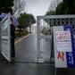 A security guard stands at the entrance to an apartment complex reserved for young, poor women, which has seen nearly a third of its 142 residents test positive for the coronavirus, in Daegu