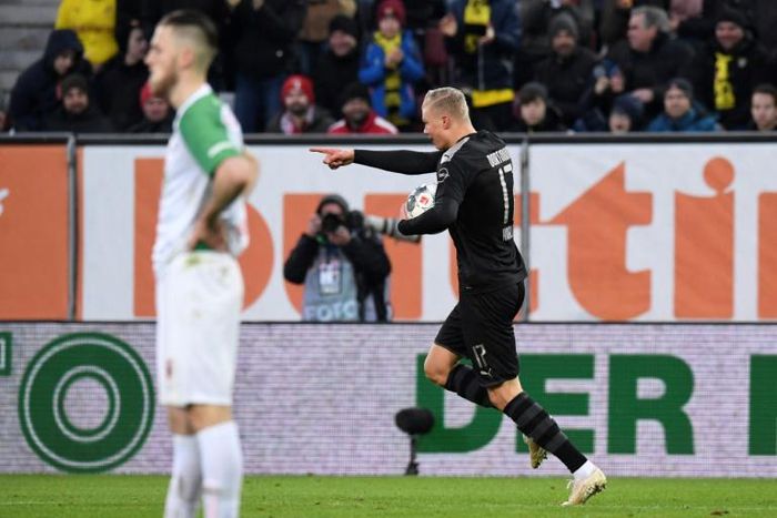 Dortmund's Norwegian forward Erling Haaland (R) celebrates his hat-trick inside 20 minutes in Saturday's stunning 5-3 league win at Augsburg.