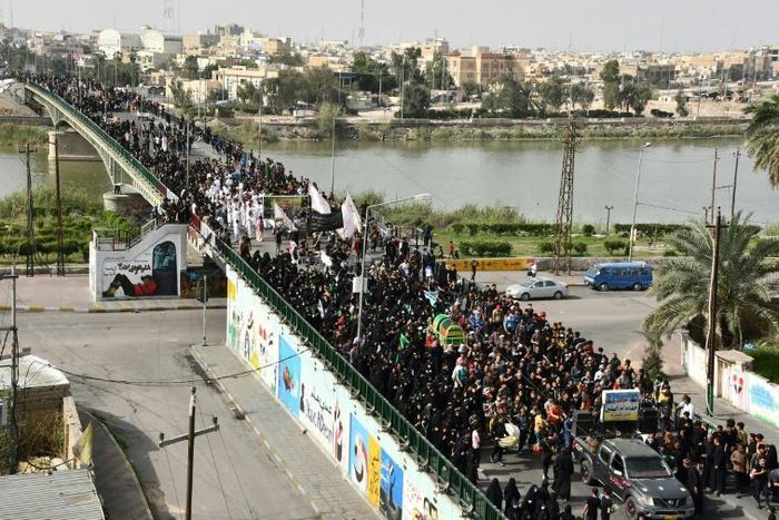 Large numbers of Iraqi Shiites defy curfews imposed to stem the spread of the coronavirus to commemorate a revered imam