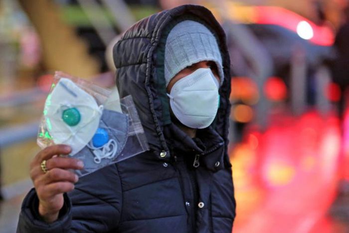 An Iranian street vendor sells protective masks in the capital Tehran