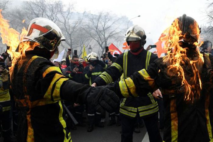 Some firefighters wearing special protective vests set fire to themselves