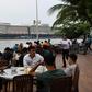 Diners have lunch in the foreground of the Westerdam cruise ship in Sihanoukville