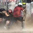 Demonstrators take cover as they clash with riot police during a protest against Chilean President Sebastian Pinera's government in Santiago, on January 17, 2020