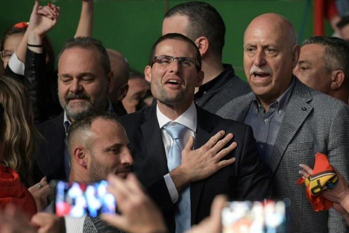 Malta's new Labour party leader and incoming PM Robert Abela (C) who has pledged to strengthen rule of law arrives to deliver his first speech during the closing event of the party conference