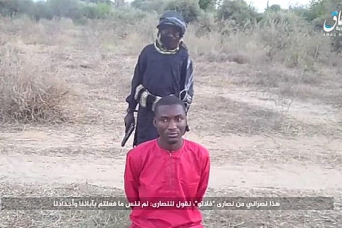 Daciya Dalep, a university student, on his knees moments before he was executed by a Boko Haram terrorist [Amaq News]