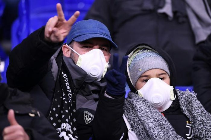 Juventus supporters wear protective face masks as a safety measure against the COVID-19