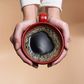 "Woman holding coffee cup, close-up, overhead view"
