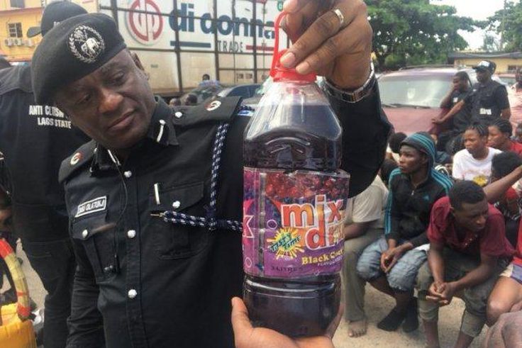 An illustrative photo of a police officer displaying a bottle containing skuchies drink. [gpowerradio]