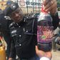 An illustrative photo of a police officer displaying a bottle containing skuchies drink. [gpowerradio]