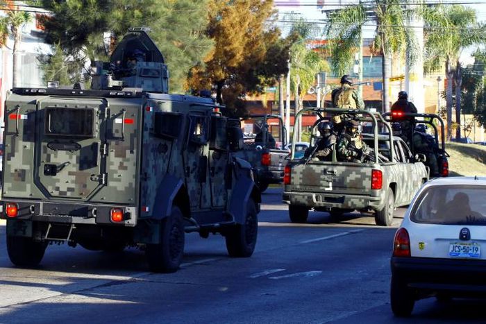 Mexican soldiers with an armoured car patrol the streets during a 2014 operation against the Jalisco Next Generation narcotics cartel