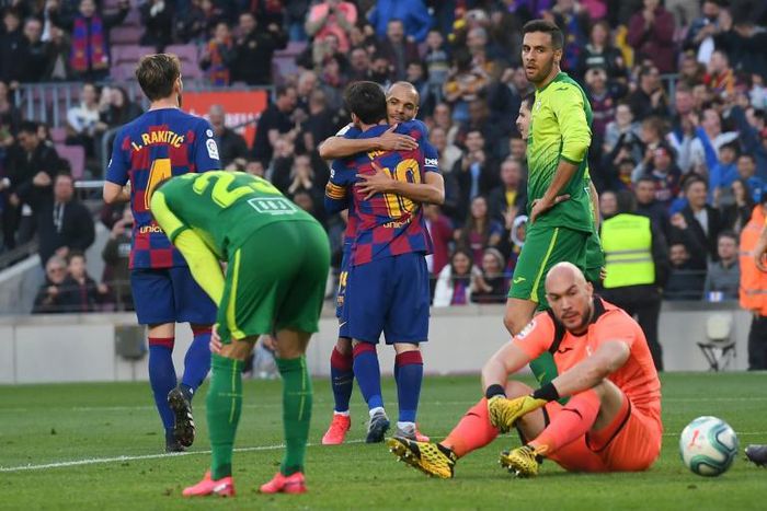 Lionel Messi celebrates with Martin Braithwaite after Braithwaite set up Messi's fourth goal in Barcelona's 5-0 win over Eibar on Saturday.