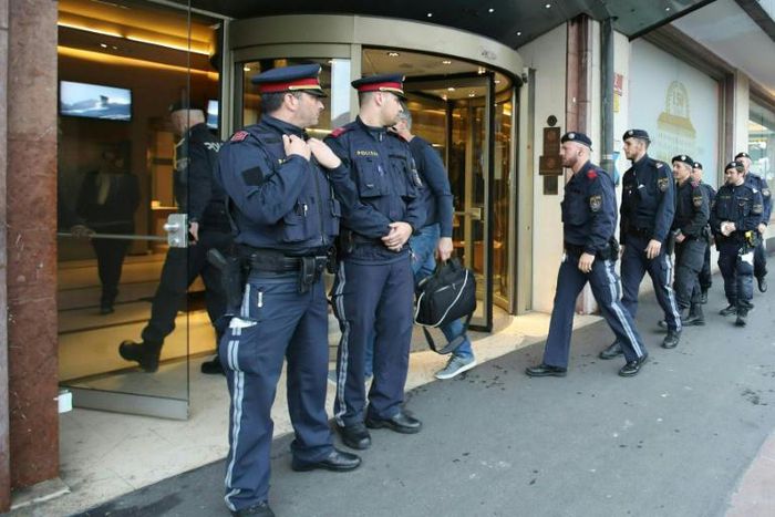 Police officers close a hotel near the city centre in Innsbruck on February 25 after a woman who worked there was confirmed to have coronavirus