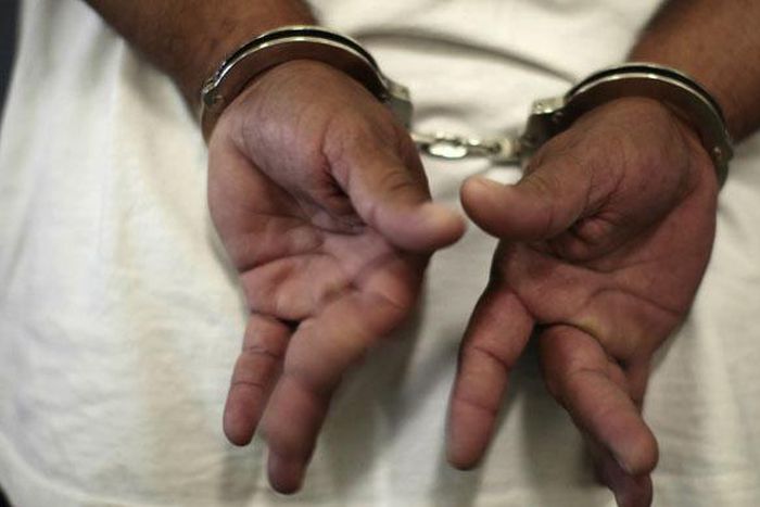 A woman in handcuffs