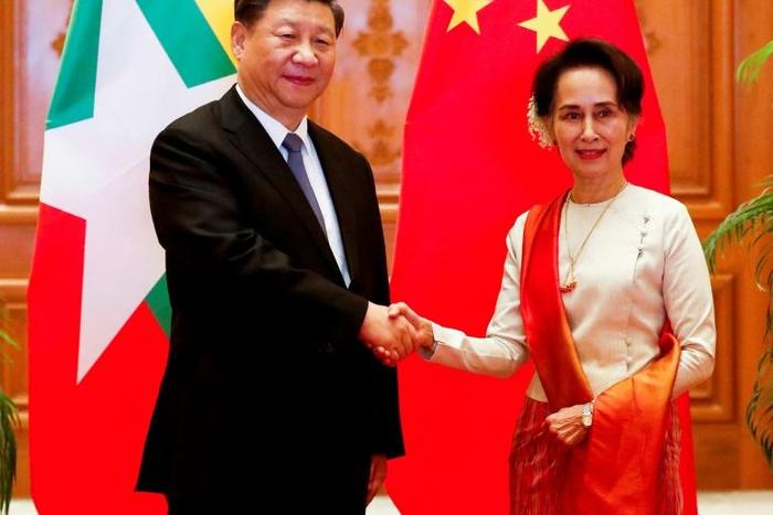 A scatalogical translation error in the name of Chinese President Xi Jinping (L) most notably appeared on the official Facebook page of Myanmar's civilian leader Aung San Suu Kyi (R)