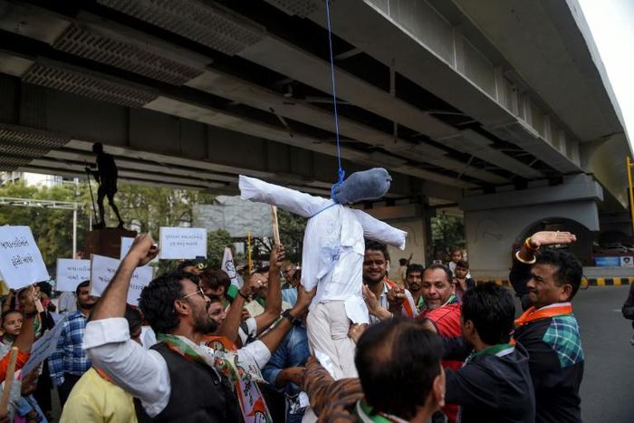 Demonstrators from the National Congress Party hang and beat a dummy of a rapist as they protest against sexual violence