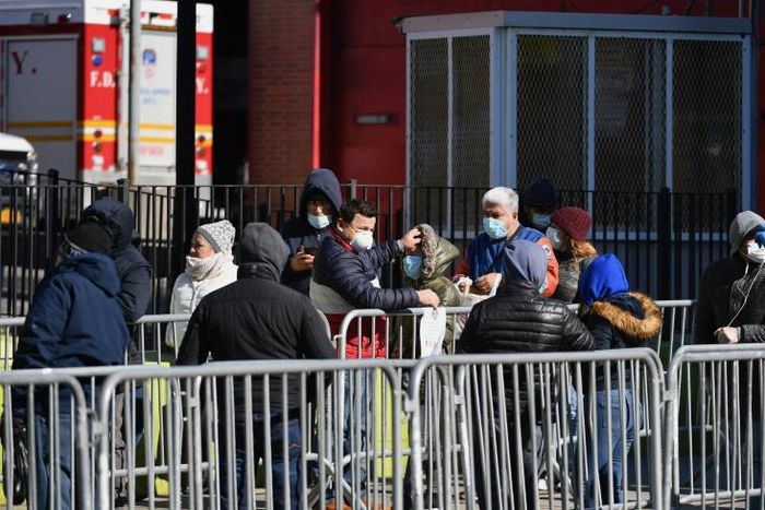 New Yorkers queue outside Elmhurst Hospital Center in Queens to get tested for the coronavirus