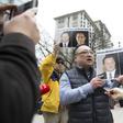 People hold photos of detained Canadians Michael Spavor and Michael Kovrig outside British Columbia Supreme Court, in Vancouver, on March 6, 2019