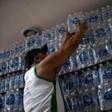 In this file photo taken on January 15, 2020, a man buys bottled water at a liquor store in the Lapa neighborhood of Rio de Janeiro