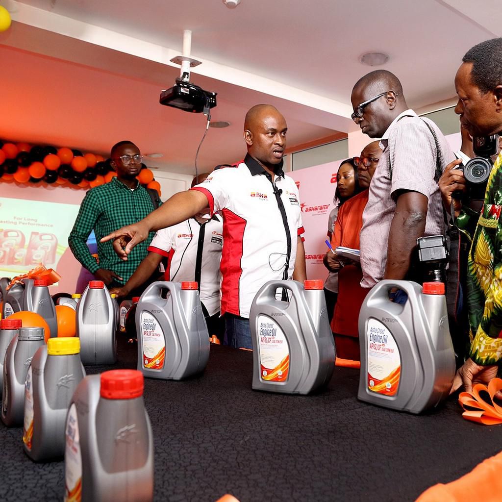 Oluwaseun Yussuf ( Sales manager) showing the different ASHA Engine oil SKU