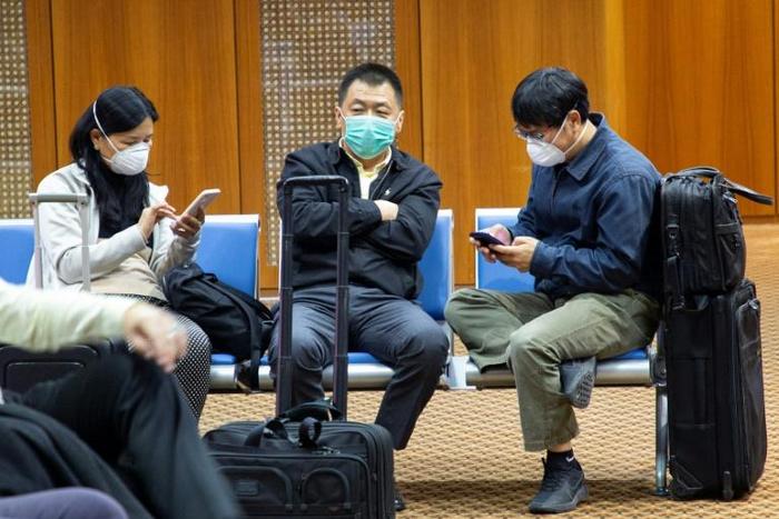 Passengers wearing masks to protect against the new coronavirus are pictured at Basra airport in southern Iraq in late January