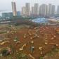 Workers toiled day and night amid a forest of earthmovers and trucks carting goods around the site, southwest of the centre of the city of 11 million