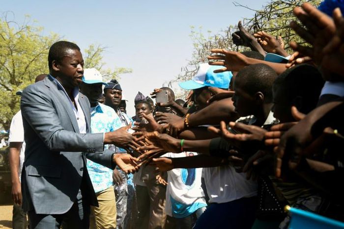 Press the flesh: President Faure Gnassingbe on the campaign trail in northern Togo. His family has been in power for more than half a century