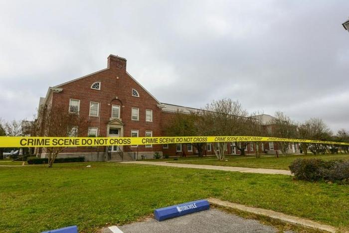 Police tape cordons off an area after a shooting at the Pensacola Naval Air Station in December 2019